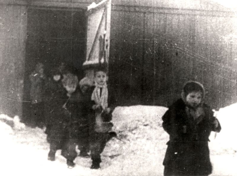Children are seen leaving a barrack after the liberation of Nazi German death camp Auschwitz-Birkenau in 1945 in Nazi-occupied Poland, in this handout picture