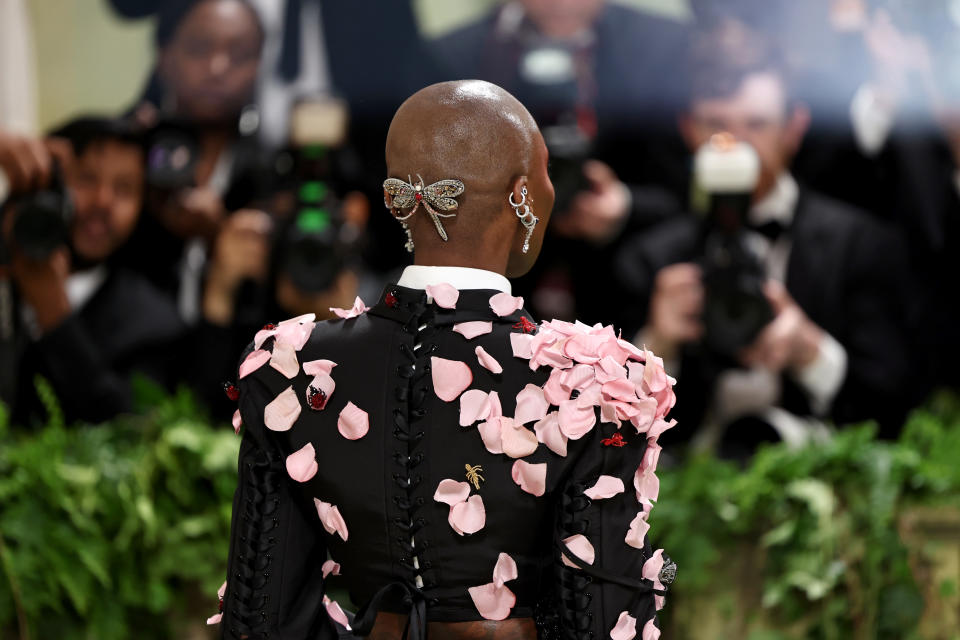 The back of Cynthia Erivo's head with a broach attached to it.