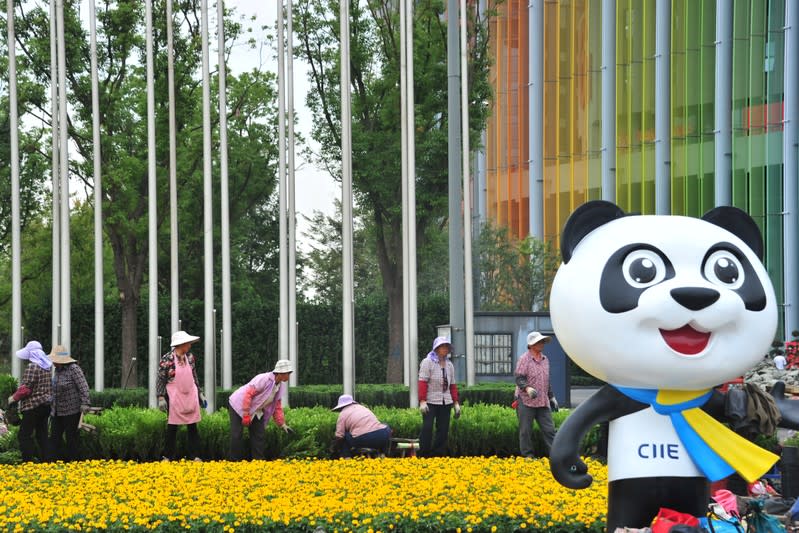 Women work on a garden at the venue for the upcoming second China International Import Expo in Shanghai