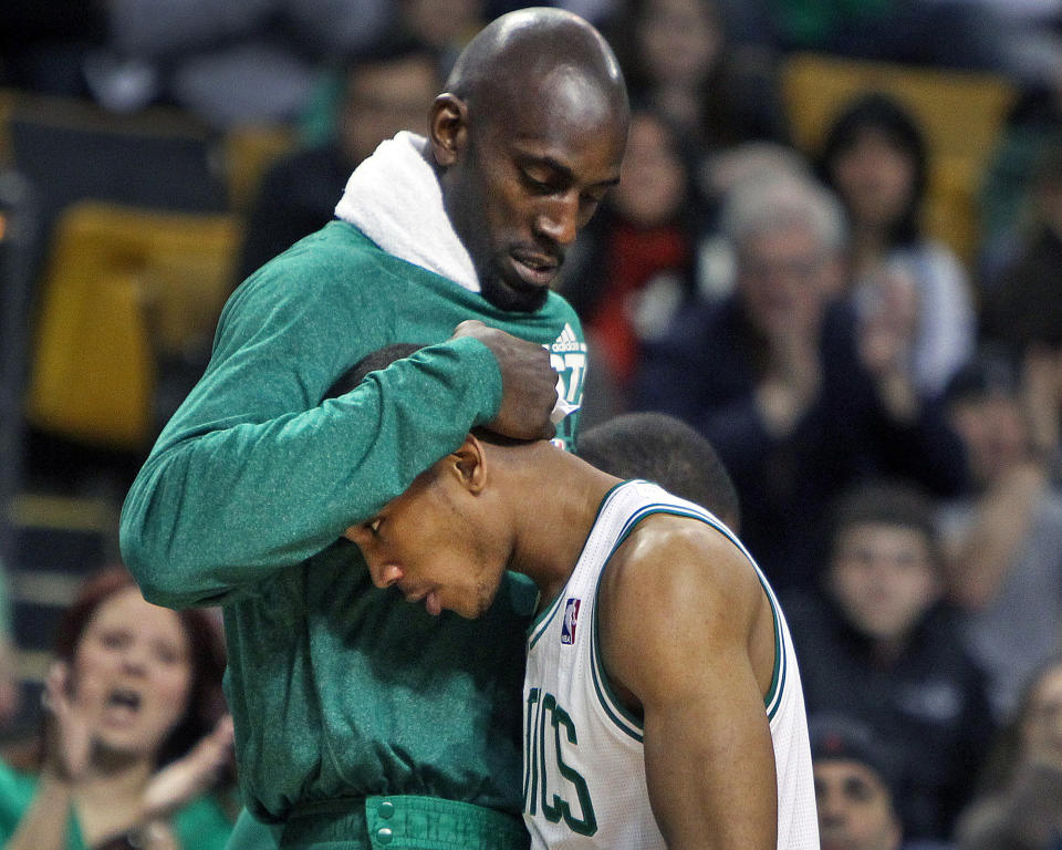 Avery Bradley (right) gets a hug from Kevin Garnett during a 2012 game at TD Garden. (Jim Davis/The Boston Globe/Getty Images)