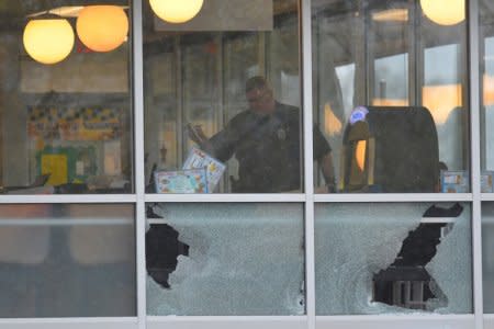 FILE PHOTO: Metro Davidson County Police inspect the scene of a fatal shooting at a Waffle House restaurant near Nashville, Tennessee, U.S., April 22, 2018.  REUTERS/Harrison McClary