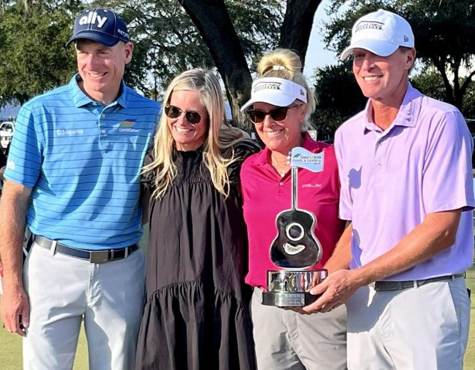 Steve Stricker (far right) displays the trophy for winning the 2022 Constellation Furyk & Friends title. He will be back Oct. 6-8 to defend. From the left are tournaments hosts Jim and Tabitha Furyk and Nikki Stricker, who caddied for her husband.