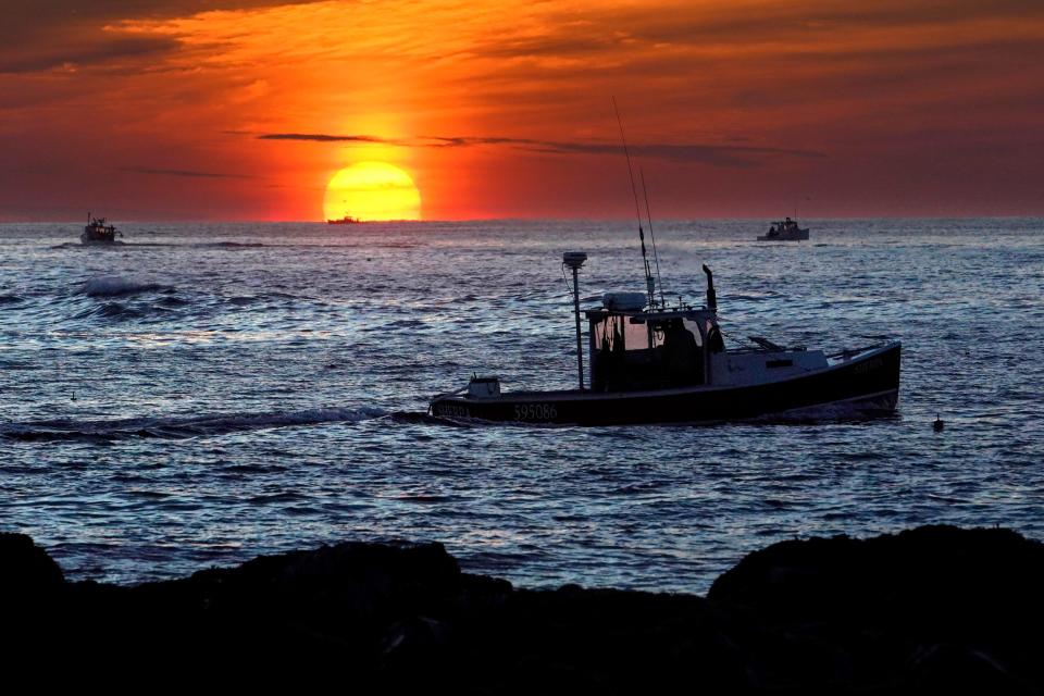 Lobster fishermen work at sunrise, Thursday, Sept. 8, 2022, off Kennebunkport, Maine. The waters off New England logged the second-warmest year in their recorded history in 2022, according to researchers.