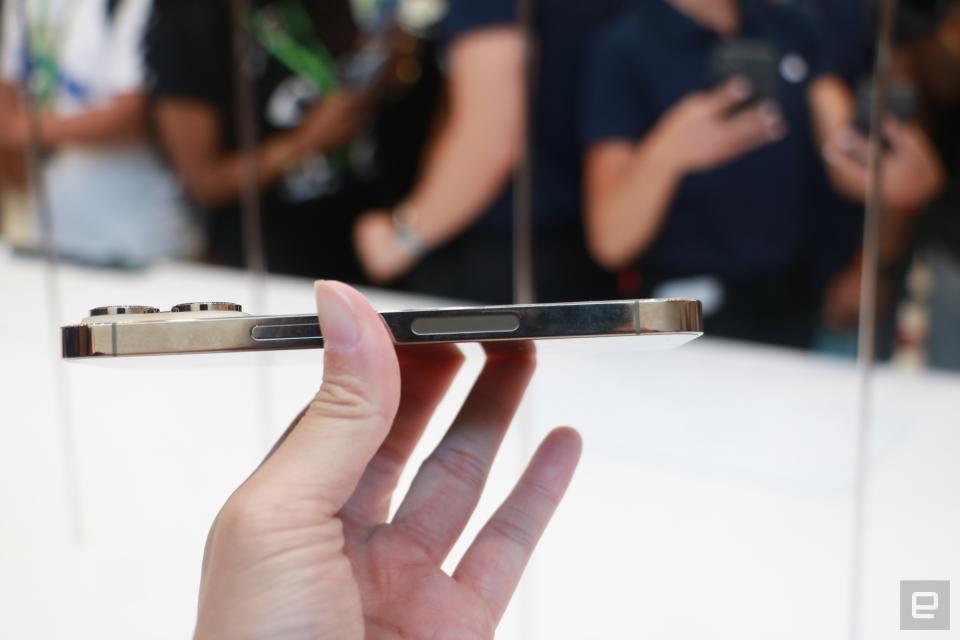 <p>Side view of the iPhone 14 Pro held in mid-air.</p> 