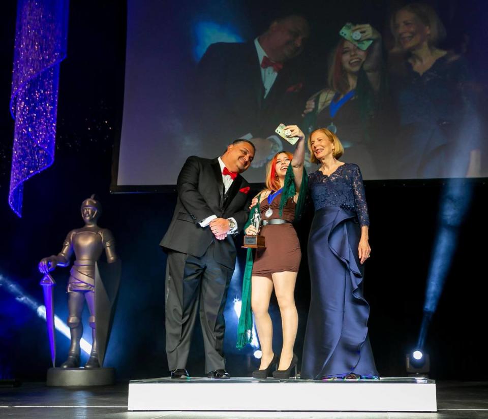 Silver Knight winner in Art Anabelle Figueroa, from Coral Reef Senior High, takes a selfie with Alex Mena, the managing editor of the Miami Herald and el Nuevo Herald, and Joan Chrissos, the education and health editor of the Miami Herald, after receiving her award during the Miami Herald & el Nuevo Herald 64th Silver Knight Award Ceremony at the James L. Knight Center in downtown Miami, Florida on Thursday, May 26, 2022.