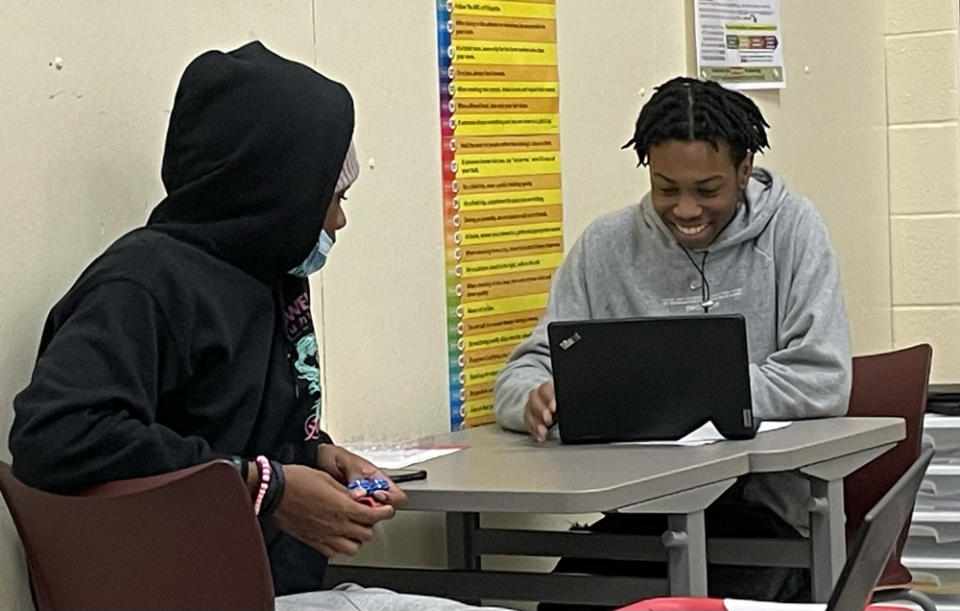 Darryn Williams, a senior in Creekside High School’s Tribe Academy, read over a classmate’s essay. Williams said the program helped him pass the math classes he needed for graduation. (Linda Jacobson/The 74)