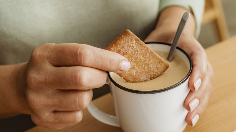 Dipping cookie into Spanish latte