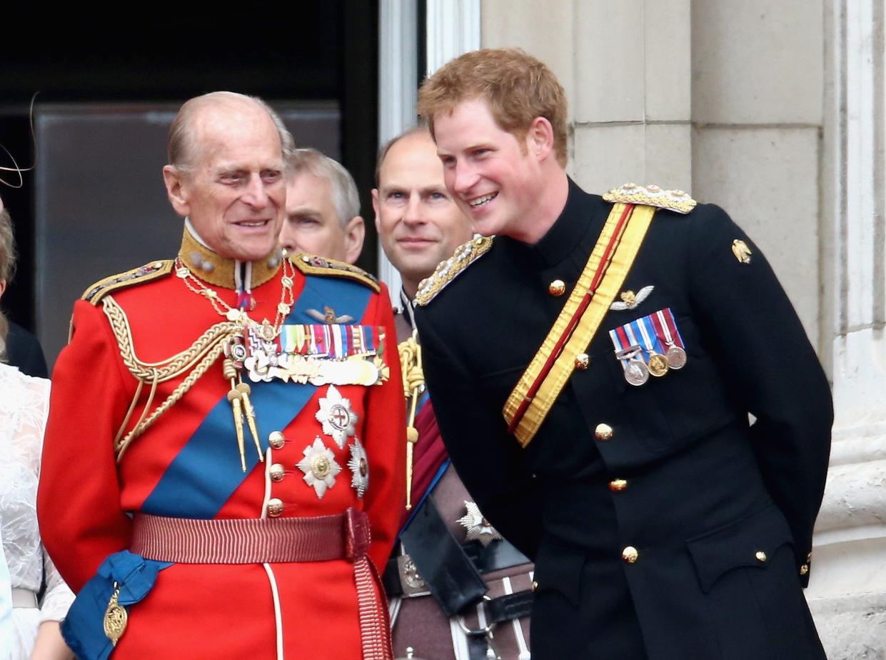 <p>The Duke of Edinburgh and Prince Harry share a joke during Trooping the Colour in 2014</p> (Getty)