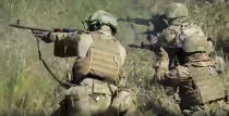 FILE - In this photo taken from video released by Russian Defense Ministry Press Service on Sept. 19, 2022, members of a special forces unit of the Russian army aim their weapons in action at an unspecified location in Ukraine. A day after the referendums were announced, Putin on Wednesday Sept. 21, 2022, ordered a partial mobilization of reservists to bolster his forces in Ukraine. (Russian Defense Ministry Press Service via AP, File)