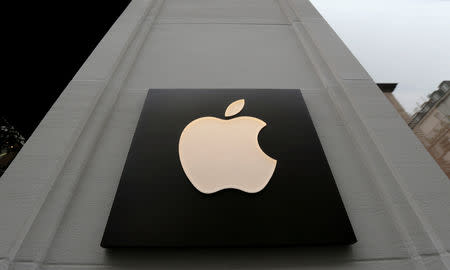 FILE PHOTO: The company's logo is seen outside Austria's first Apple store, which opens on February 24, during a media preview in Vienna, Austria, February 22, 2018. REUTERS/Heinz-Peter Bader/File Photo