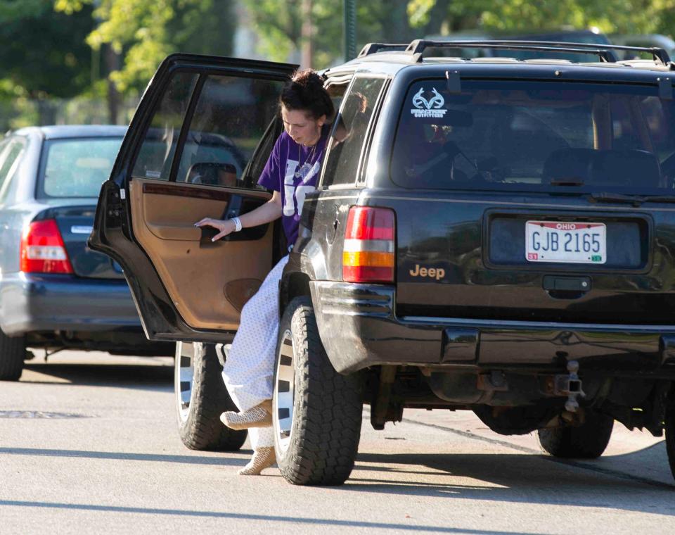 Cheyanne Willis, at left, gets into a vehicle in front of her home, July 9, 2017. Less than 12 hours earlier, two gunmen barged into the home and shot nine people, including Willis. Three of those shot were children. One female was killed. James Echols and Michael Sanon are currently on trial, Jan. 12, 2022, for the killing Autum Garrett, 22. The day before, there was a gender reveal party for her at her home in Colerain Township. It was later revealed she was never pregnant.