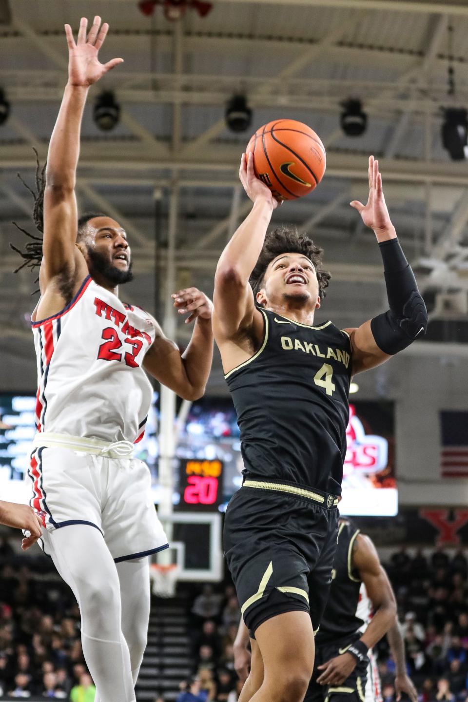 Oakland forward Trey Townsend (4) goes to the basket against Detroit Mercy forward Damezi Anderson (23) during the first half at the O'rena in Rochester on Friday, Feb. 17, 2023.