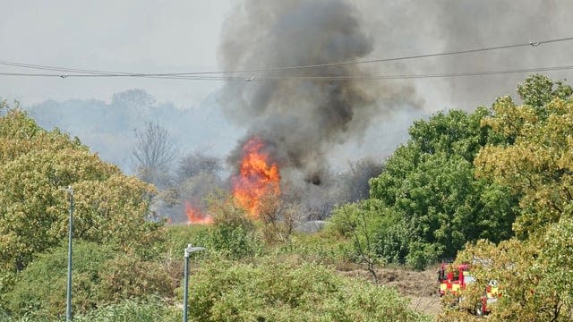 Firefighters tackling a fire on Dartford Marshes in Kent on July 19 2022 (Adrian Stirrup/PA)