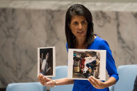 <p>APR. 5, 2017 – U.S. Ambassador to the United Nations Nikki Haley holds up photos of victims of the Syrian chemical attack during a meeting of the United Nations Security Council at U.N. headquarters, April 5, 2017 in New York City. The Security Council is held emergency talks following the worst use of chemical weapons in Syria since the Ghouta attack in 2013. (Photo: Drew Angerer/Getty Images) </p>