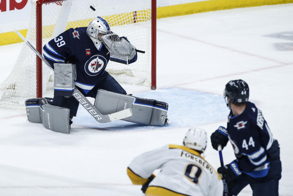 Nashville Predators' Filip Forsberg (9) scores on Winnipeg Jets goaltender Laurent Brossoit (39) during the second period of an NHL match in Winnipeg, Manitoba, on Thursday, Nov. 9, 2023. (John Woods/The Canadian Press via AP)