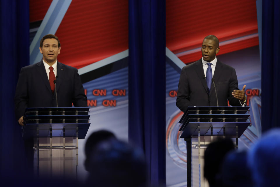 FILE - In this Sunday, Oct. 21, 2018 file photo, Republican gubernatorial candidate Ron DeSantis, left and Democratic gubernatorial candidate Andrew Gillum, right, speak during a CNN debate in Tampa, Fla. The candidates for Florida governor are scheduled to debate for the second and final time, three days after their first testy encounter. DeSantis and Gillum will meet Wednesday night, Oct. 24, 2018, at a community college near Fort Lauderdale. (AP Photo/Chris O'Meara, File)