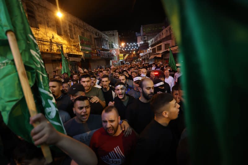 Palestinians in the West Bank protest against what they believed to be an Israeli strike on a hospital in Gaza on Tuesday. Israel said it is investigating the explosion and that it could have been caused by an errant Hamas rocket launch. Photo by Alaa Badarneh/EPA-EFE