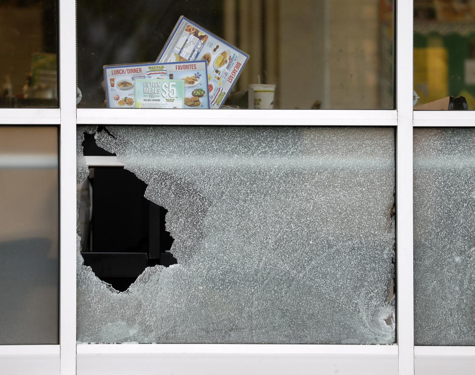 <p>Menus and a cup sit on a table next to a window shot out at a Waffle House restaurant Sunday, April 22, 2018, in Nashville, Tenn. At least four people died after a gunman opened fire at the restaurant early Sunday. (Photo: Mark Humphrey/AP) </p>