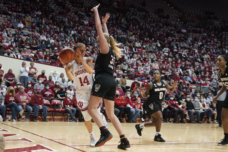 Indiana's Ali Patberg (14) passes the ball as North Carolina State's Elissa Cunane (33) defends during the second half of an NCAA college basketball game Thursday, Dec. 2, 2021, in Bloomington, Ind. (Darron Cummings)