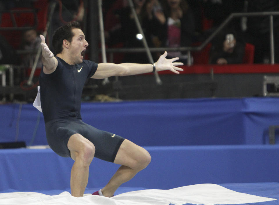 France's Renaud Lavillenie celebrates after setting a new world indoor record of 6.16 meters, at the "Pole Vault Stars" event at Donetsk in eastern Ukraine, Saturday, Feb. 15, 2014. Lavillenie broke Sergei Bubka's 21-year-old indoor pole vault world record. (AP Photo/str)