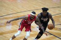 New Orleans Pelicans forward Brandon Ingram loses the ball to Miami Heat forward Jimmy Butler (22) during the second half of an NBA basketball game in New Orleans, Thursday, March 4, 2021. The Heat won 103-93. (AP Photo/Gerald Herbert)