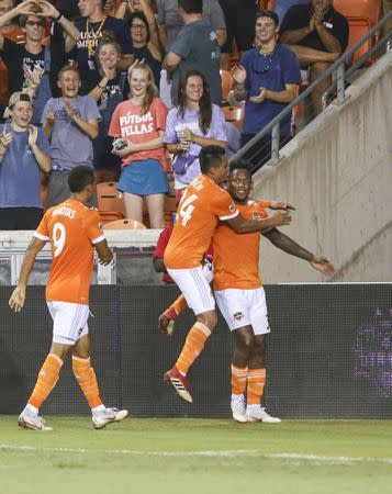 Jul 18, 2018; Houston, TX, USA; Houston Dynamo forward Romell Quioto (31) celebrates with midfielder Darwin Ceren (24) after scoring a goal during the second half against Sporting Kansas City at BBVA Compass Stadium. Mandatory Credit: Troy Taormina-USA TODAY Sports