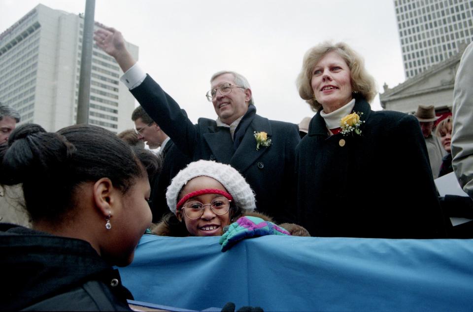 New Gov. Don Sundquist waves as he greets the inauguration parade coming up Deaderick Street after his swearing-in and address ceremonies Jan. 21, 1995. Looking on the parade are new First Lady Martha Sundquist and seven-year-old Ashley Manson, with glasses, daughter of Ruth Johnson, commissioner of the Revenue Department.