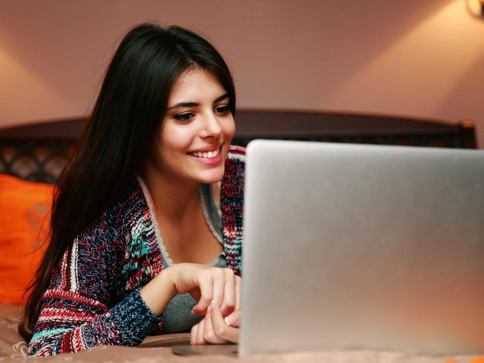 girl watching tv on laptop