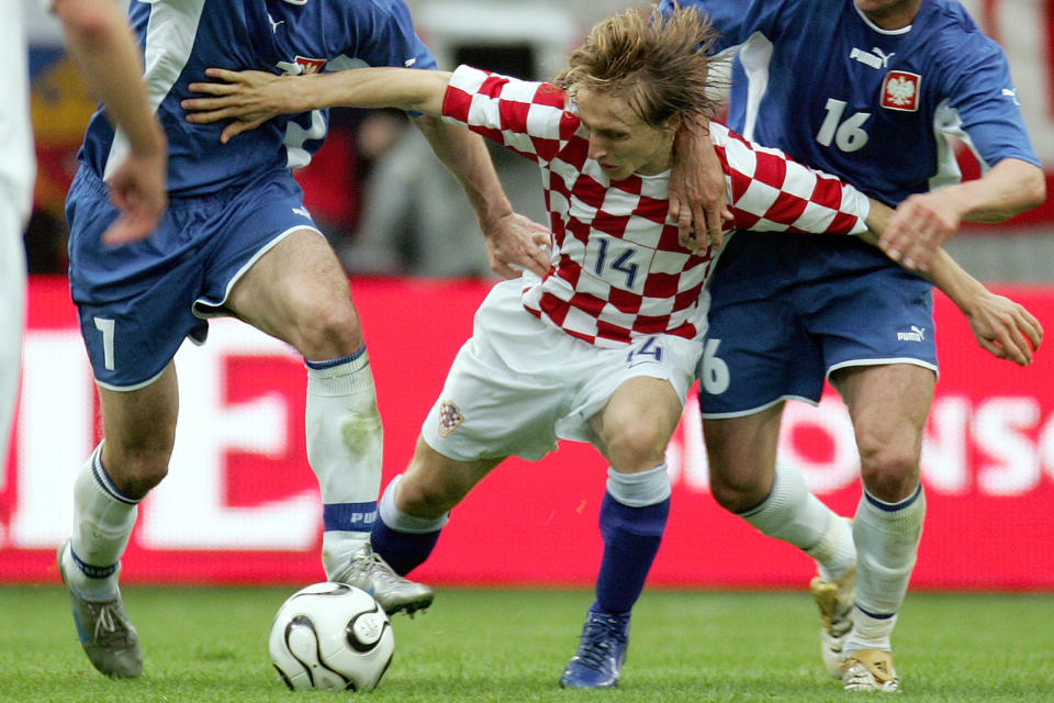 FILE - Croatia's Luka Modric is attacked during a friendly soccer match between Poland and Croatia as a preparation for the upcoming soccer World Cup in Wolfsburg, northern Germany, Saturday, June 3, 2006. Portugal's Cristiano Ronaldo and Croatia's Modric go to Euro 2024 showing age is no boundary for soccer's modern stars. (AP Photo/Fabian Bimmer, File)