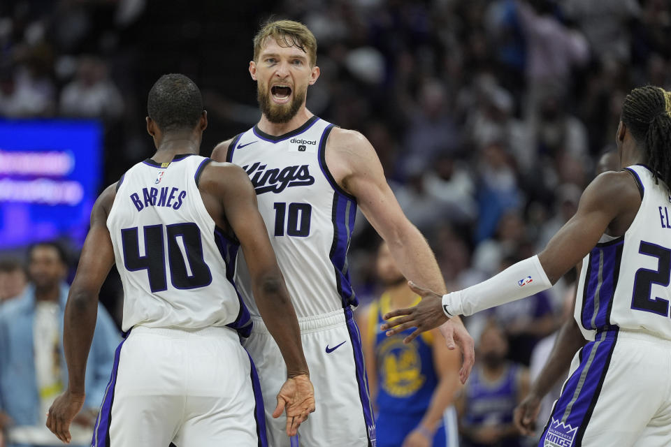 Sacramento Kings forward Domantas Sabonis (10) celebrates with Harrison Barnes (40) during the second half of the team's NBA basketball play-in tournament game against the Golden State Warriors, Tuesday, April 16, 2024, in Sacramento, Calif. (AP Photo/Godofredo A. Vásquez)