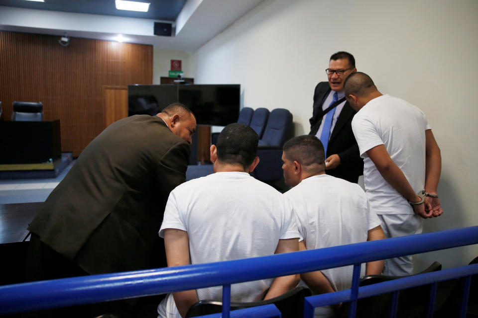 Three former El Salvador police officers, seen here conferring with their lawyers during their trial, were found guilty in late July of aggravated homicide in the killing early last year of Diaz C&oacute;rdova. For years, members of El Salvador's LGBTQ community have been especially vulnerable to violence in the nation. (Photo: Jose Cabezas / Reuters)