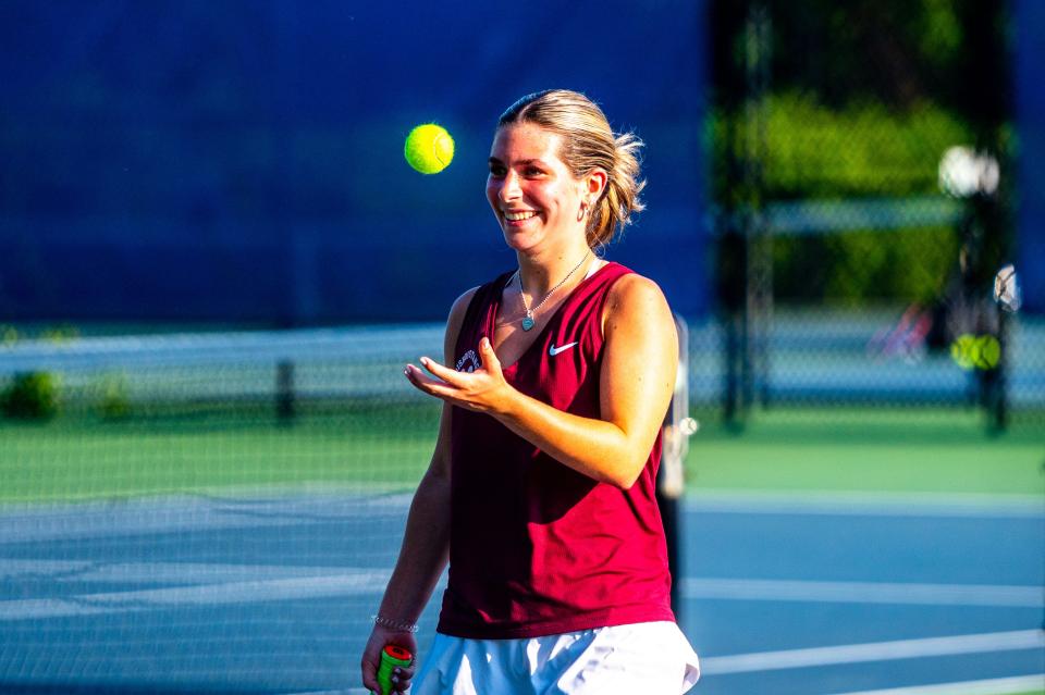 Bishop Stang's Lexy Wynn is all smiles as her teammates cheer her on.