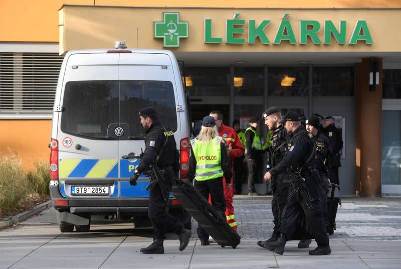 Police officers walks outside the University Hospital, which was a site of a shooting, in Ostrava