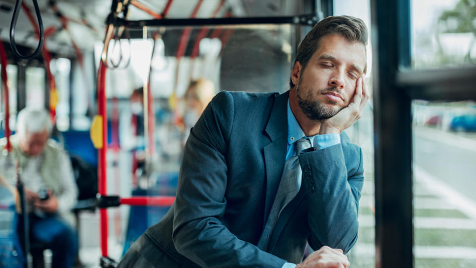 How much sleep do you need? A man napping on public transport