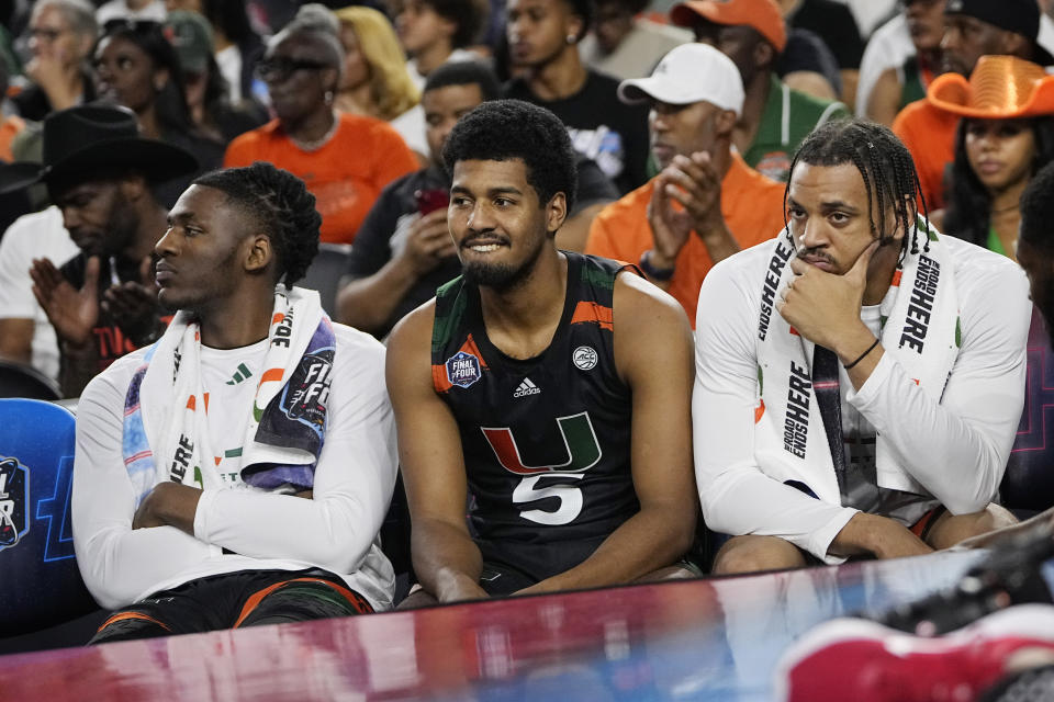 Miami players watch during the second half of a Final Four college basketball game against Connecticut in the NCAA Tournament on Saturday, April 1, 2023, in Houston. (AP Photo/David J. Phillip)