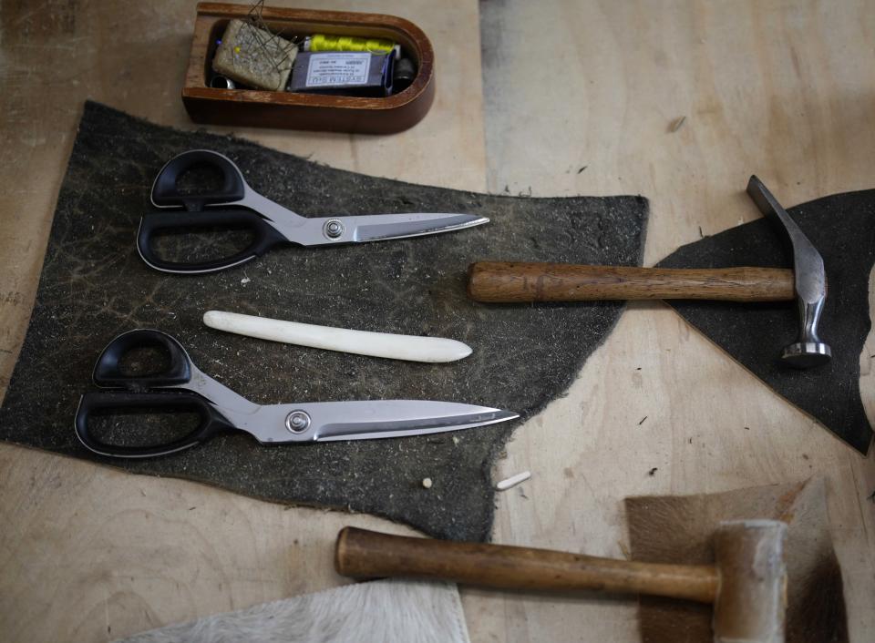 Tools lie in the shop of Saddler Klaus Bensmann, in Bad Hindelang, Germany, Wednesday, Sept. 13, 2023. Bensmann produces tailored leather trousers and vests with hand embroidery. The leather comes from the alpine region and is tanned in Germany. (AP Photo/Matthias Schrader)