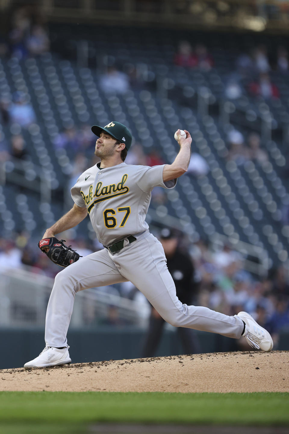 Oakland Athletics pitcher Zach Logue throws to a Minnesota Twins batter during the first inning of a baseball game Friday, May 6, 2022, in Minneapolis. (AP Photo/Stacy Bengs)