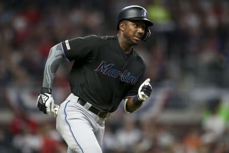 FILE PHOTO: Apr 6, 2019; Atlanta, GA, USA; Miami Marlins center fielder Lewis Brinson (9) hits a single against the Atlanta Braves in the seventh inning at SunTrust Park. Mandatory Credit: Brett Davis-USA TODAY Sports/File Photo