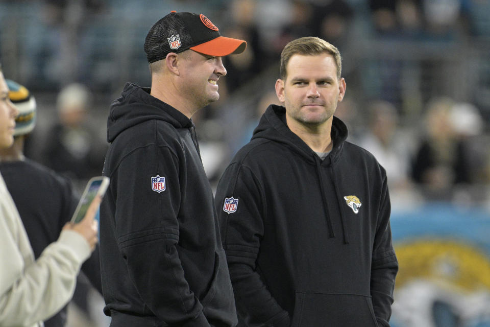 Cincinnati Bengals head coach Zac Taylor, left, talks to his brother Jacksonville Jaguars offensive coordinator Press Taylor, before an NFL football game, Monday, Dec. 4, 2023, in Jacksonville, Fla. (AP Photo/Phelan M. Ebenhack)