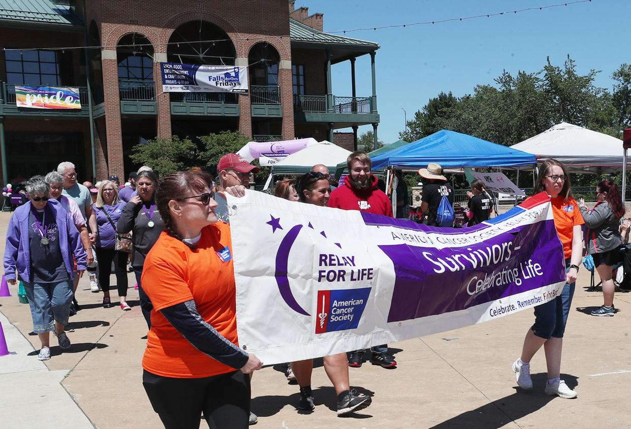 Cancer survivors walk during Relay for Life.