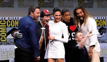 Cast members (L-R) Ben Affleck, Ezra Miller, Gal Gadot, Ray Fisher and Jason Momoa pose with moderator Chris Hardwick at a panel for "Justice League" during the 2017 Comic-Con International Convention in San Diego, California, U.S., July 22, 2017. REUTERS/Mario Anzuoni