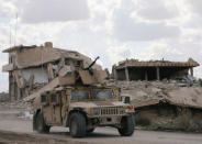 FILE PHOTO: A fighter from the Syrian Democratic Forces (SDF) rides on a vehicle in the village of Baghouz, Deir Al Zor province, Syria, February 18, 2019. REUTERS/Rodi Said/File Photo