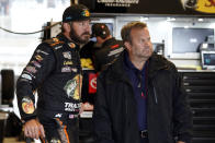 Martin Truex Jr, left, talks to a crew member before practice for Sunday's NASCAR Cup Series auto race at the Circuit of the Americas in Austin, Texas, Saturday, May 22, 2021. (AP Photo/Chuck Burton)