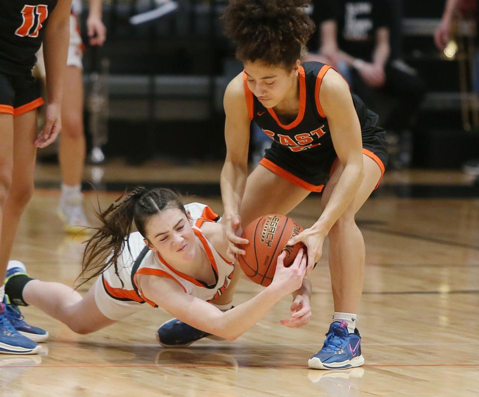 Ames' Natalya Deardorff (11) and Waterloo East guard Nyla Norman (5) battle for a loose ball during the second half of the Little Cyclones' 41-33 loss.