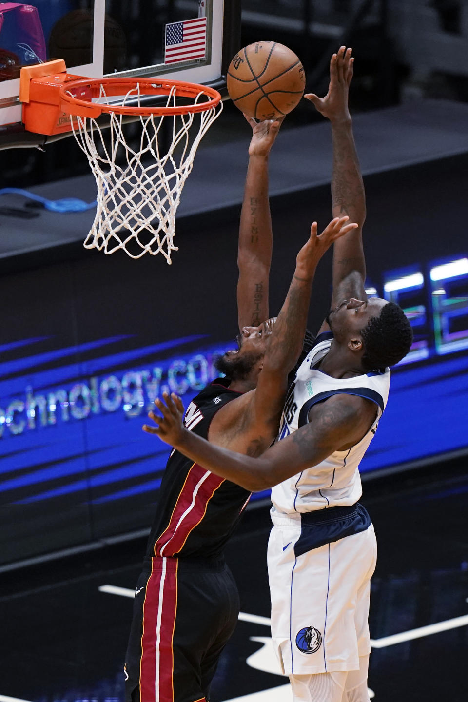 Miami Heat forward Trevor Ariza, left, goes up for a shot against Dallas Mavericks forward Dorian Finney-Smith during the first half of an NBA basketball game, Tuesday, May 4, 2021, in Miami. (AP Photo/Wilfredo Lee)