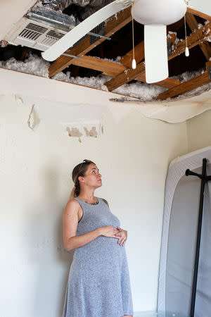 Jennifer Maher, pregnant in her third trimester, looks over damage to her home post-Hurricane Florence at Marine Corps Base Camp Lejeune, North Carolina, U.S., September 27, 2018. REUTERS/Andrea Januta