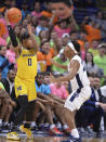 Michigan's Dug McDaniel (0) looks to pass around Penn State's Jalen Pickett (22) during the first half of an NCAA college basketball game, Sunday, Jan. 29, 2023, in State College, Pa. (AP Photo/Gary M. Baranec)