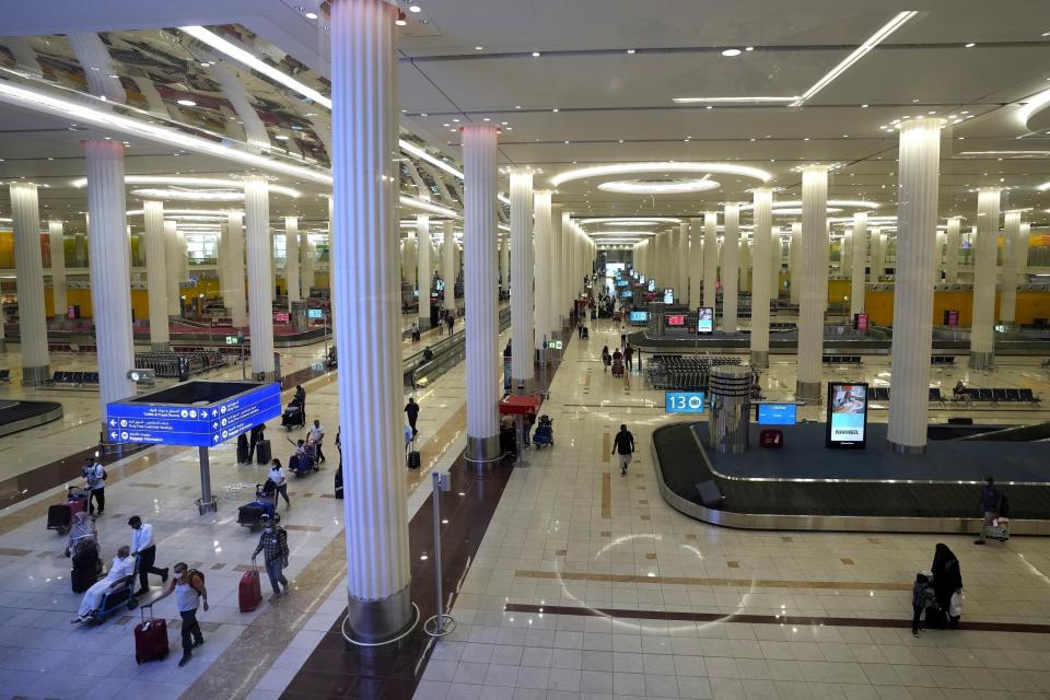 FILE - Passengers leave the baggage handling hall at the Dubai International Airport terminal 3, in Dubai, United Arab Emirates, on Oct. 25, 2022. On Tuesday, May 9, 2023, the airport reported it saw over 21.2 million passengers pass through its terminals in the first quarter of the year, potentially nearing numbers it saw before the coronavirus pandemic grounded air traffic around the world. (AP Photo/Kamran Jebreili, File)