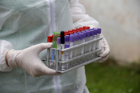FILE PHOTO: Inspector Vija Ritina holds blood test tubes to process a check on a farm in the Rezekne region July 4, 2014. REUTERS/Ints Kalnins/File Photo