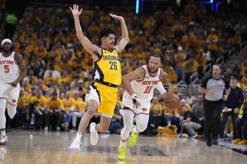 New York Knicks guard Jalen Brunson (11) drives past Indiana Pacers guard Ben Sheppard (26) during the first half of Game 6 in an NBA basketball second-round playoff series, Friday, May 17, 2024, in Indianapolis. (AP Photo/Michael Conroy)